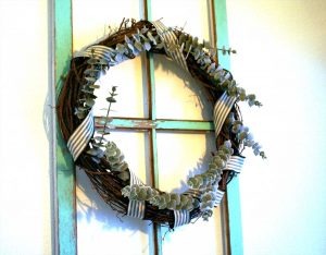 a DIY winter wreath with ribbon and eucalyptus