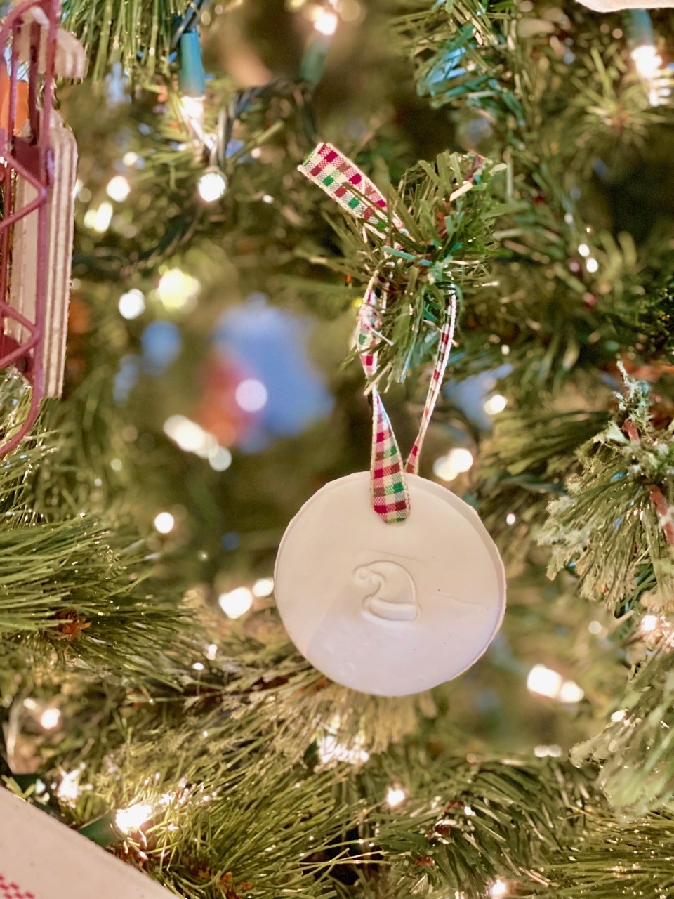 a homemade clay ornament on a Christmas tree