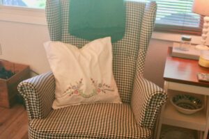 vintage embroidered pillow on chair