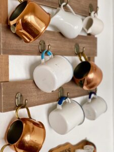 a collection of vintage cups and copper