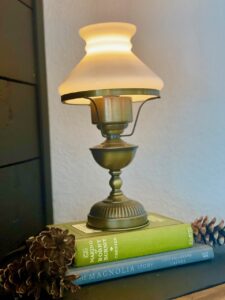 a vintage light stacked on top of vintage books