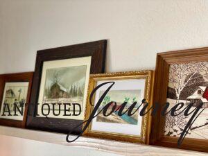 vintage barn art displayed on a picture rail