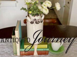 vintage books with milk glass used in a centerpiece display