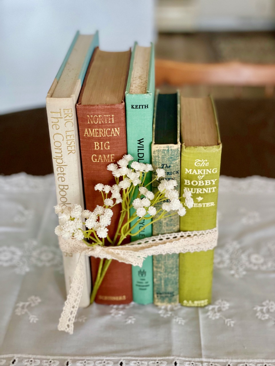 vintage books stacked with a lace ribbon