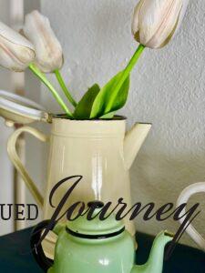 a vintage enamelware pitcher with faux Tulips