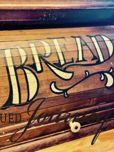 vintage wooden bread box with roll top