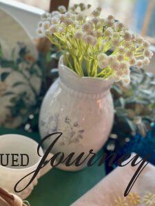 a vintage transferware vase styled as part of a vignette in a basket
