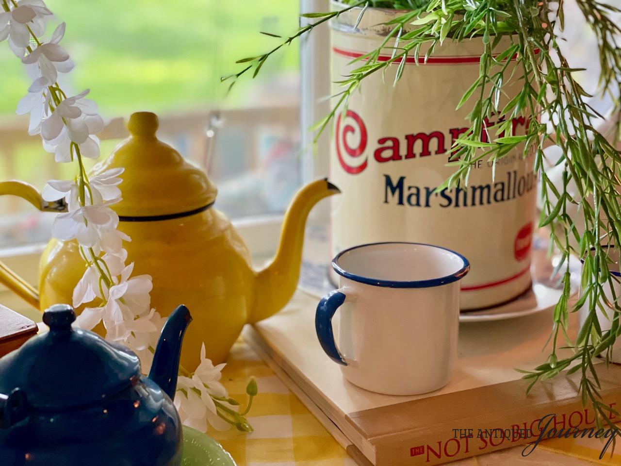 vintage enamelware with a marshmallow tin and greenery in a patriotic vignette