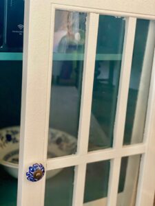 an old cabinet from Target that has been painted white with new blue and white knobs