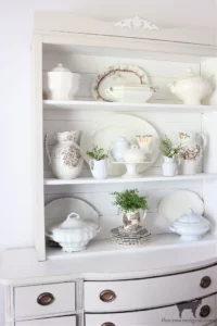 a hutch displayed with vintage dishes and Ironstone