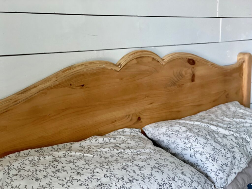 a vintage wooden headboard that has been refinished and waxed