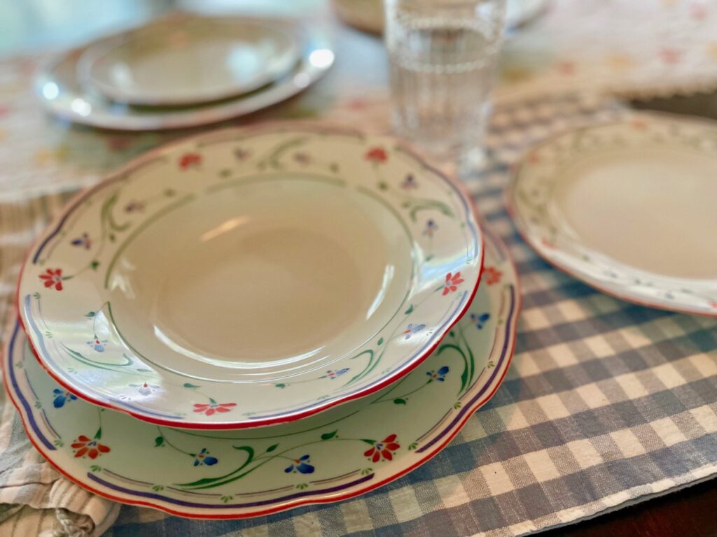 vintage floral dishes set on a table with a gingham placemat