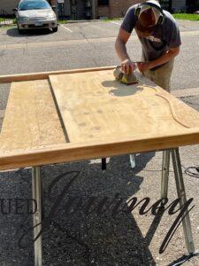 sanding a vintage wooden headboard