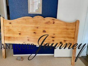 a vintage wooden headboard that has been refinished