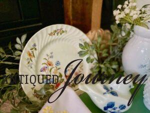 a vintage floral plate displayed in a summer basket vignette