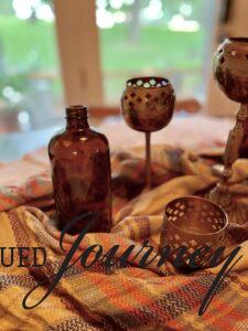 amber bottles and vintage brass candle holders used for a fall centerpiece