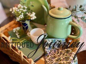 a late summer basket vignette with a mint green enamel teapot