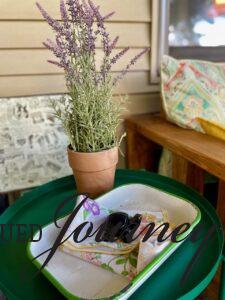 an outdoor space in late summer with a faux lavender plant and vintage napkins