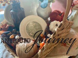 a basket full of a vintage fall decor and acorns