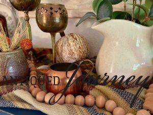 a vintage copper creamer displayed for fall