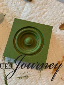 wooden rosette with green paint dry 