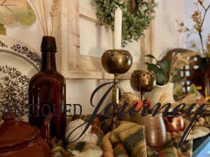 a shelf displayed with vintage decor for fall