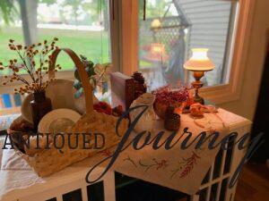 a fall vignette displayed on a cabinet top