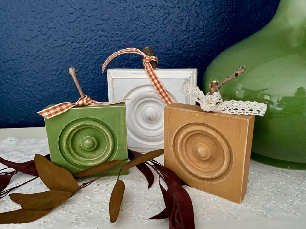 a trio of diy pumpkins made out of wooden rosettes