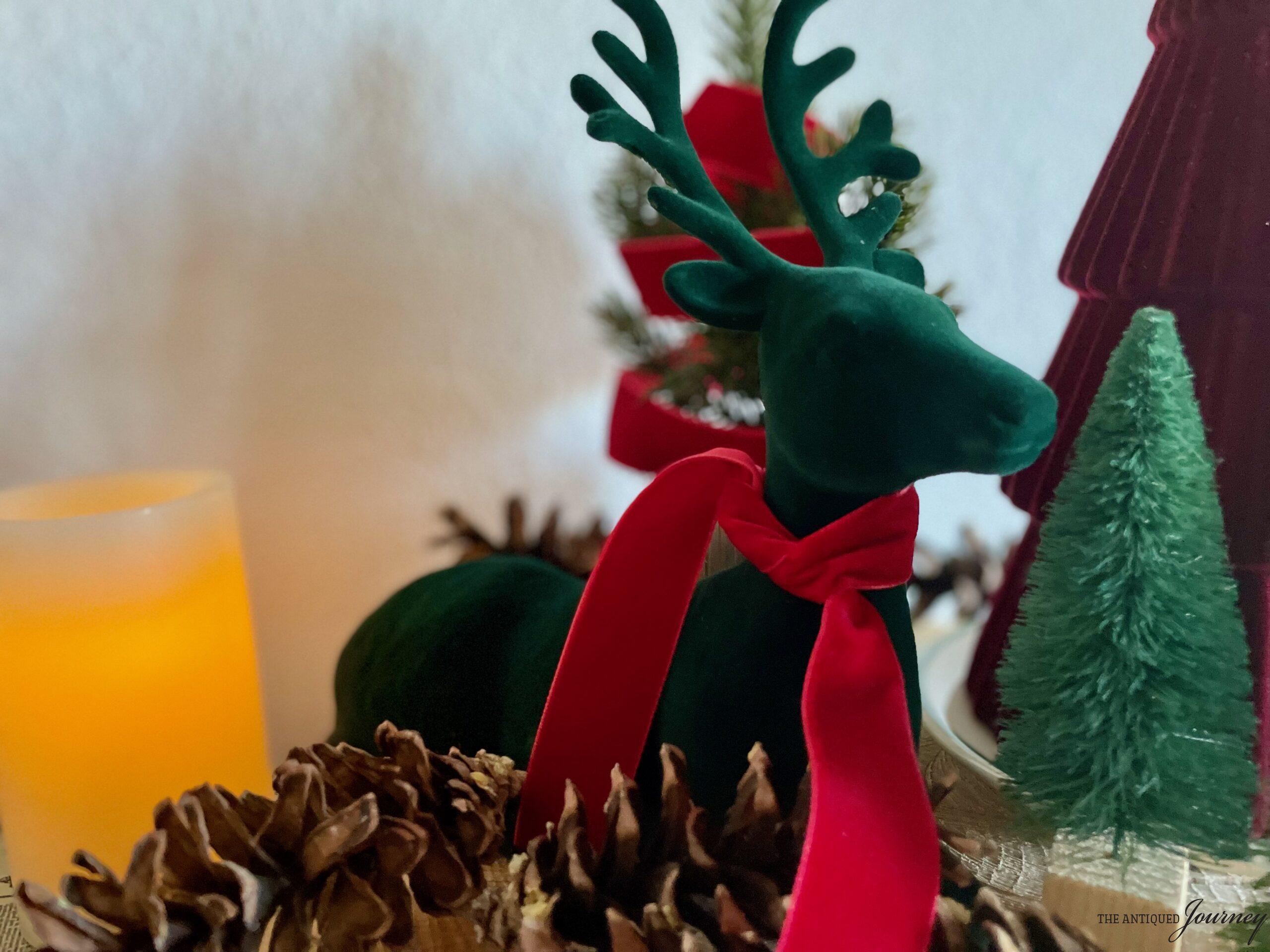 a velvet reindeer amongst bottle brush trees and pinecones
