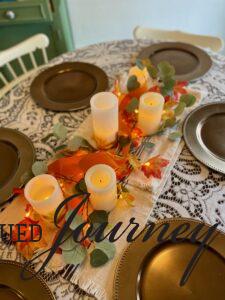 a thrifted thanksgiving centerpiece with faux pillar candles
