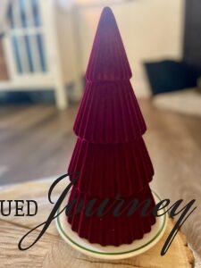 a red velvet tree used on a wood round for a Christmas display