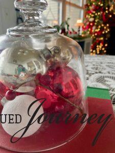 a Christmas centerpiece with vintage ornaments and berry stems