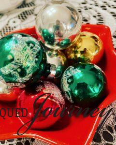 vintage ornaments displayed in a Christmas bowl