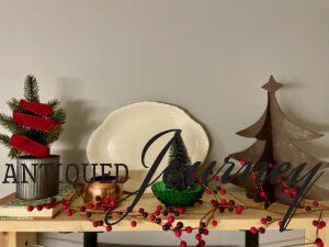 a Christmas display with vintage items and red berries
