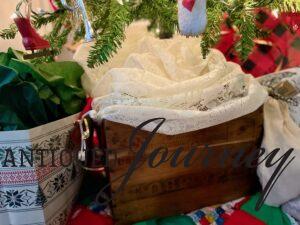 a vintage wooden crate underneath a Christmas tree for height