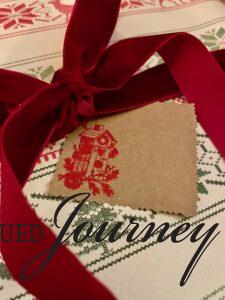 a DIY Christmas gift tag with a red bird house