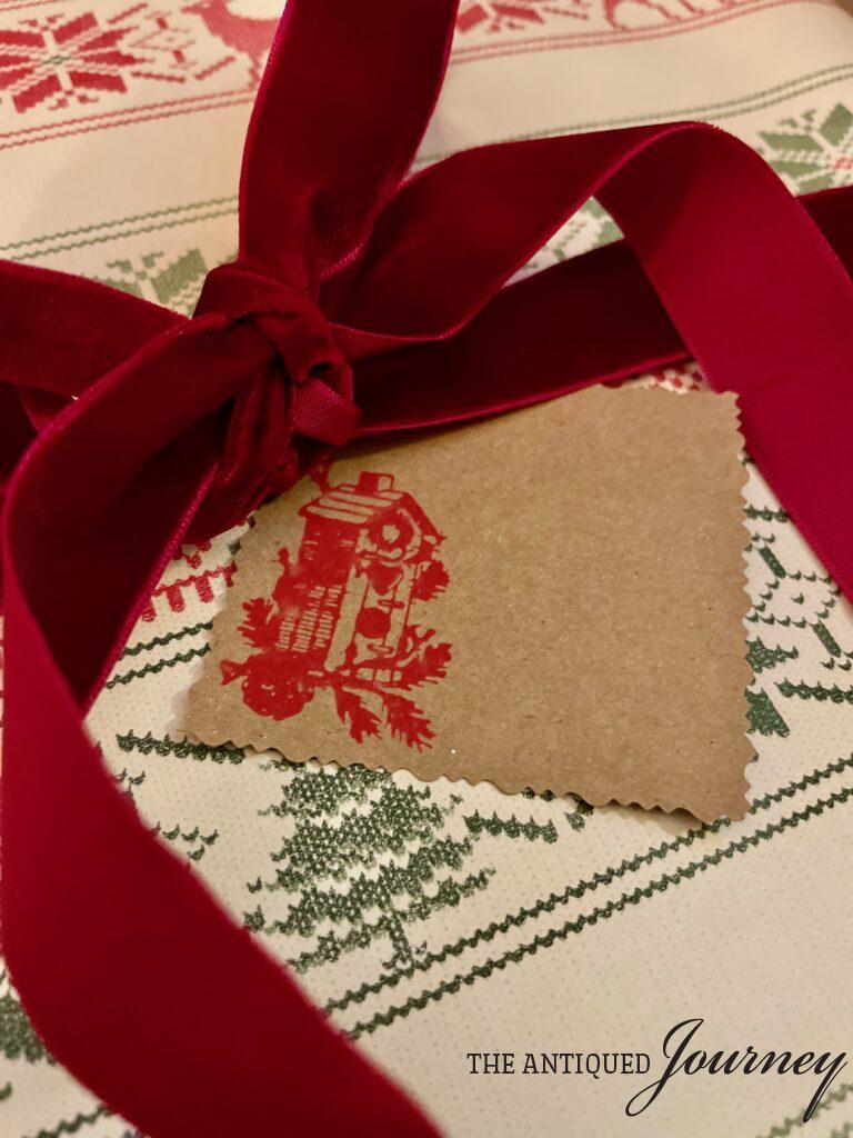 a DIY Christmas gift tag with a red bird house