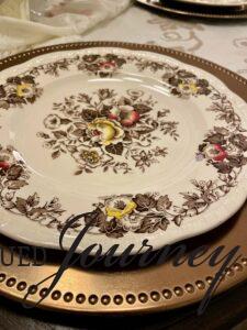 a vintage transferware plate on top of a charger