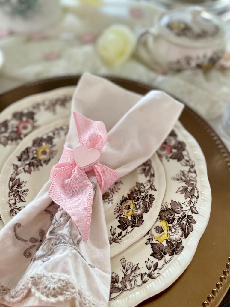 vintage transferware with a heart napkin on a styled Valentines table