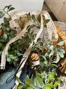 a winter basket with greenery and birch logs
