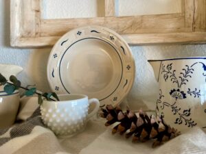 a winter shelf styled with blue and white vintage decor