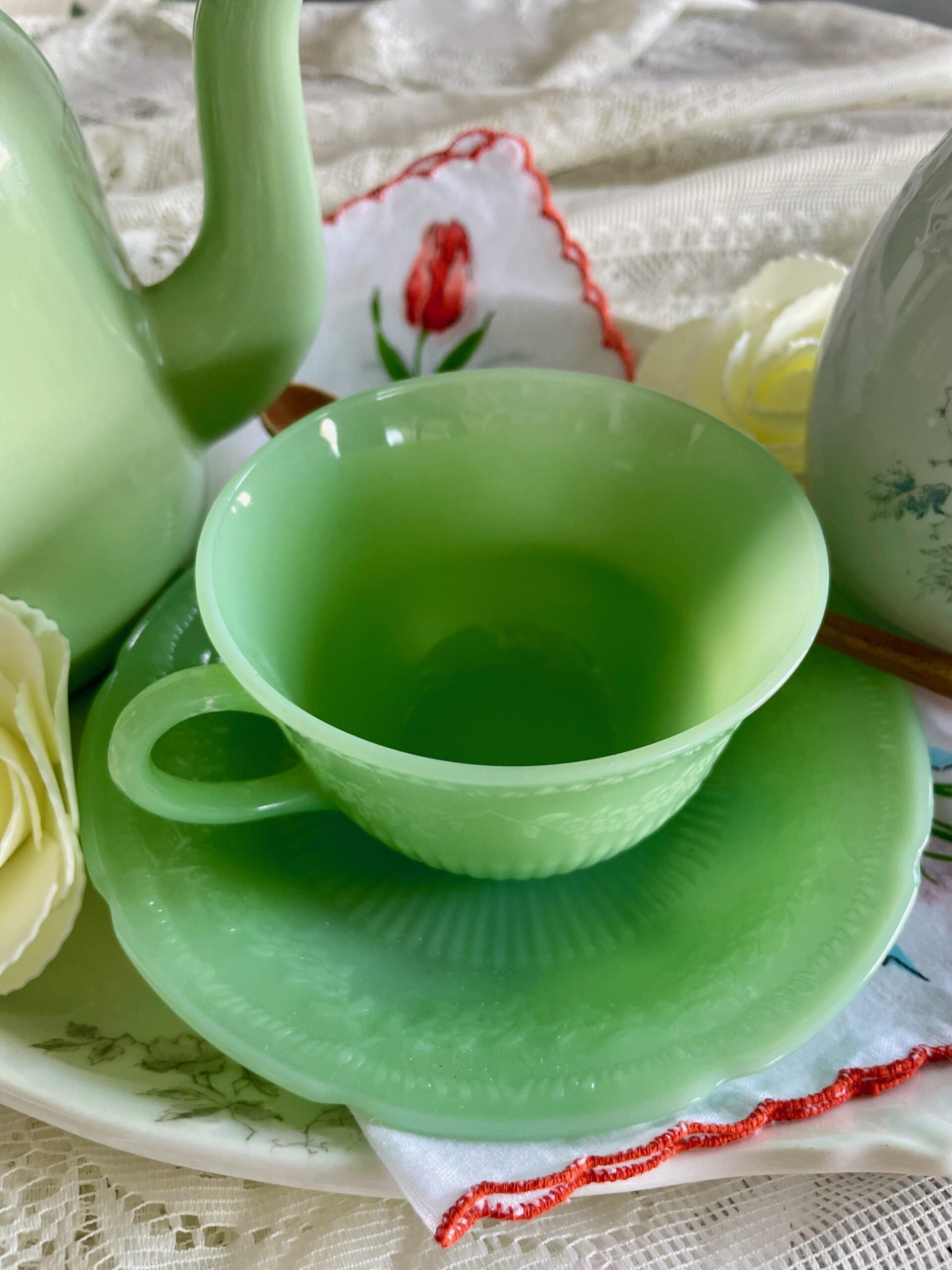a vintage Jadeite tea cup and saucer on a Ironstone platter for Spring decor