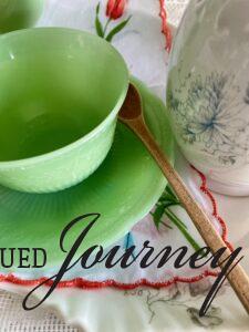 a vintage jadeite cup and saucer with a wooden stir spoon