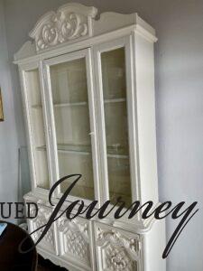a used hutch in white with crown molding