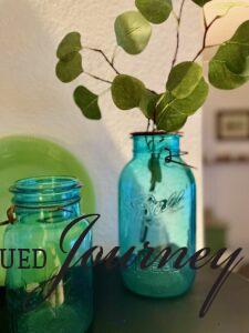 green stems in a vintage blue jar
