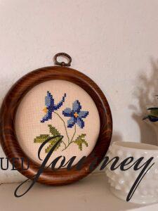 a vintage floral needlework with blue flowers