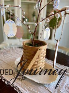 a DIY easter tree with bunny ornaments on a dining table