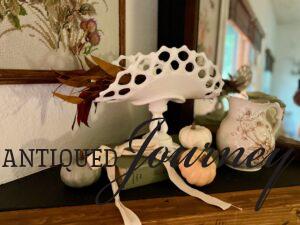 a vintage milk glass banana stand styled for fall
