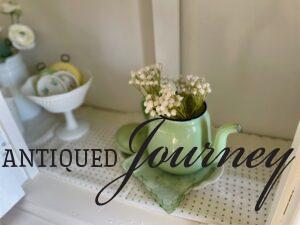 vintage decor in Spring hues used in a white hutch
