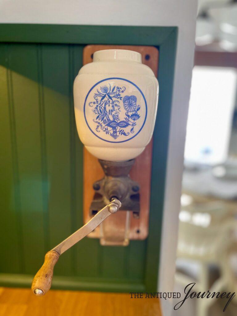 a vintage ceramic wall mount coffee grinder